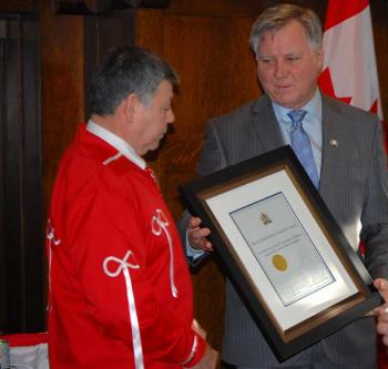 Indigenous Relations Minister Richard Feehan (right) presents President Gerald Cunningham with a plaque recognizing 80 years for the Metis Settlement General Council. (Photos by Shari Narine)