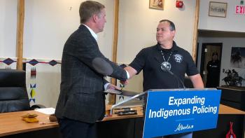 Justice Minister Tyler Shandro shakes hands with Siksika Nation Chief Ouray Crowfoot 