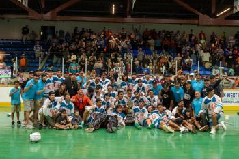 A winning team photo taken on the field of the Mann Cup lacrosse final.