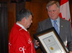 Indigenous Relations Minister Richard Feehan (right) presents President Gerald Cunningham with a plaque recognizing 80 years for the Metis Settlement General Council. (Photos by Shari Narine)