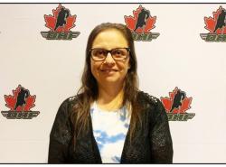 Gayle Payette stands in front of a screen printed with the logo of the Ontario Hockey Federation  