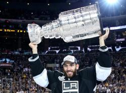 Dwight King holds the Stanley Cup over his head.