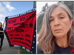 A woman holds up a button blanket with the words: Indigenous Lives Matter. RCMP killed another Wet’suwet’en Son on July 8, 2021 in Campbell River. JusticeforJared.org